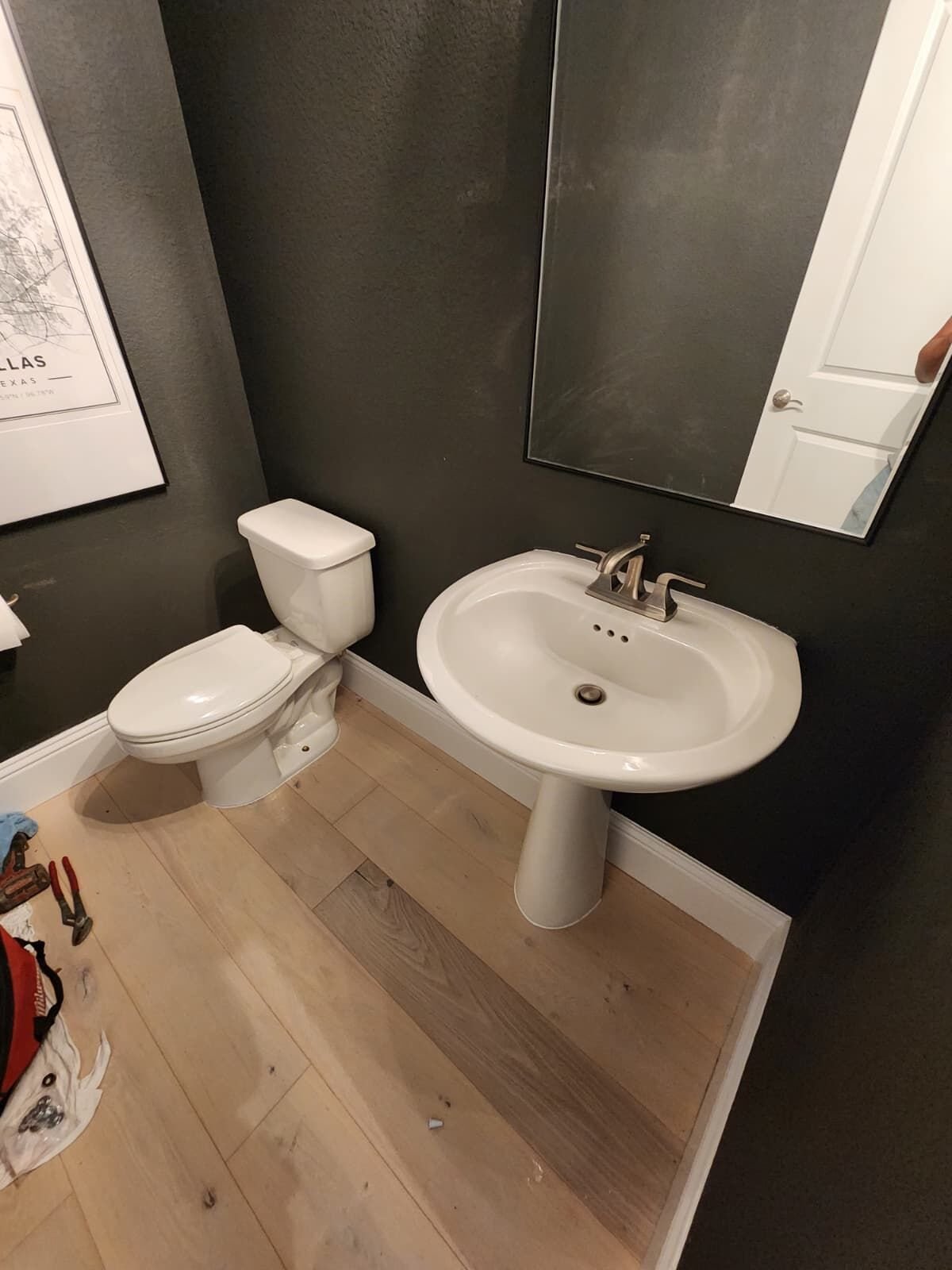 Toilet and pedestal sink installed in a finished bathroom