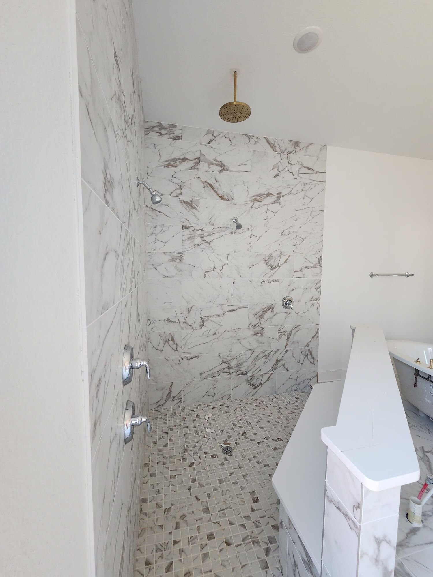 Long shower with finished tile and glass
