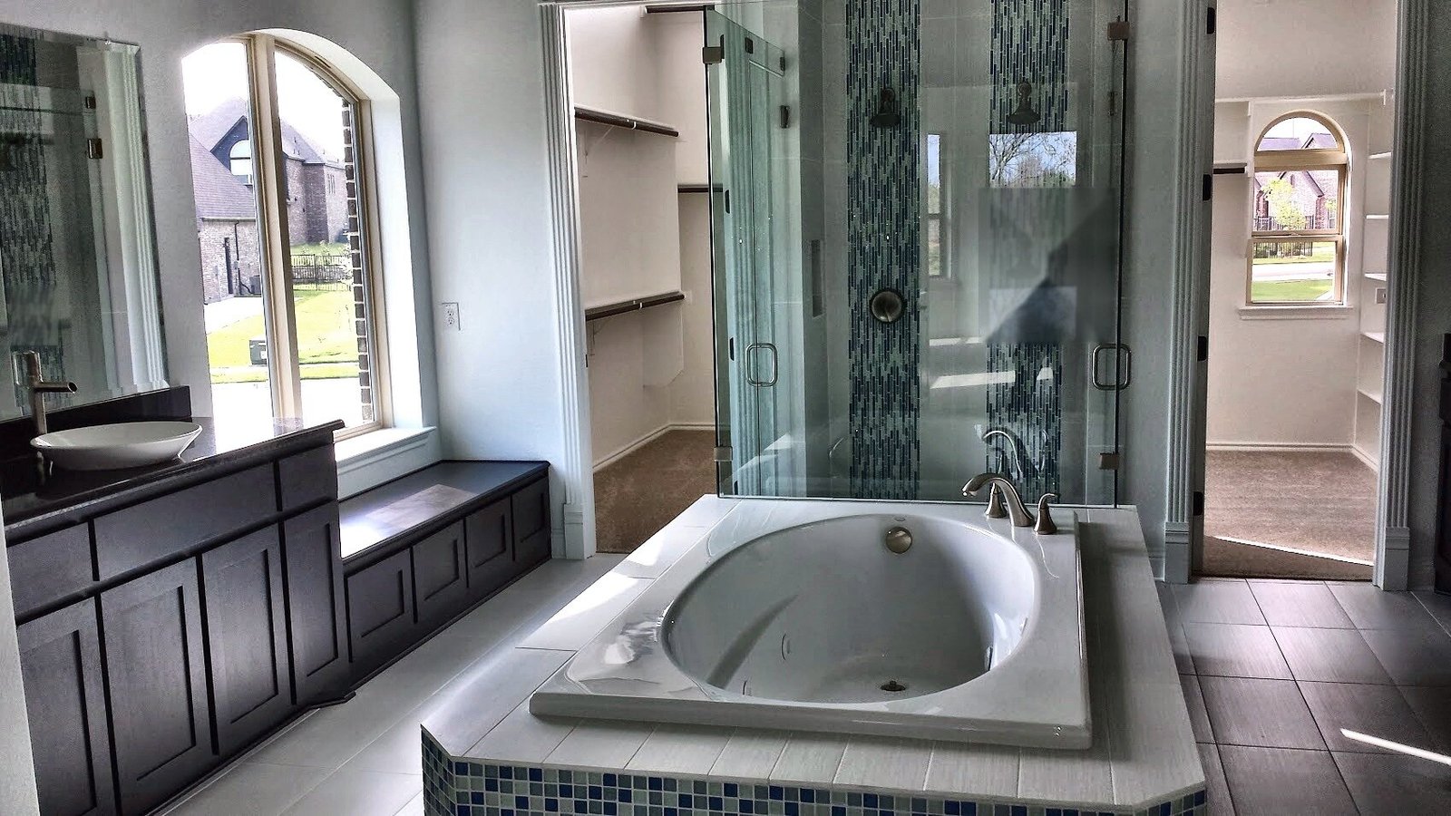 Finished master bathroom with tub, glass shower and fixtures installed