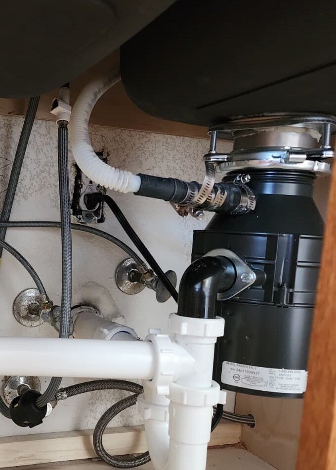 Garbage disposal connected to a kitchen sink drain